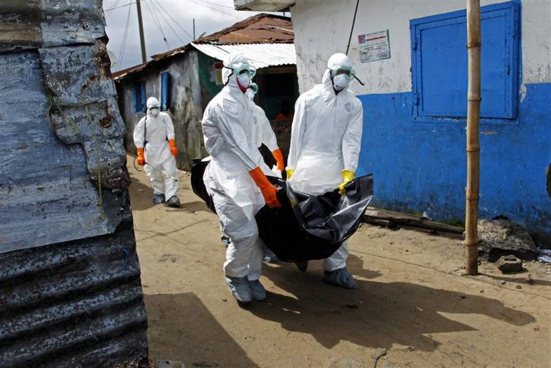 Trabajadores de la salud en Liberia recogen el cuerpo de una víctima de ébola en West Point (Monrovia). / EFE