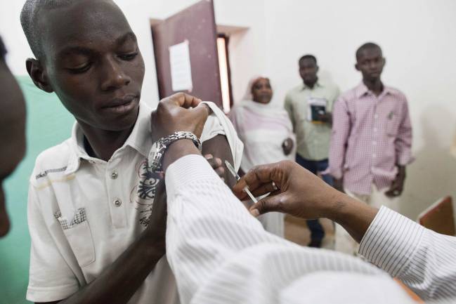 Un médico vacuna para la fiebre amarilla a un grupo de sudaneses, en Darfur. / Efe 